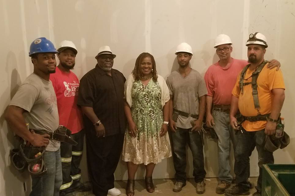 A photo of Dr. Kathy Humphrey with construction workers building the CEC in Homewood