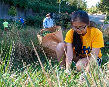 a student volunteering in a garden