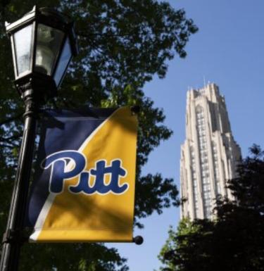 a banner with "pitt" on it and the cathedral in the background