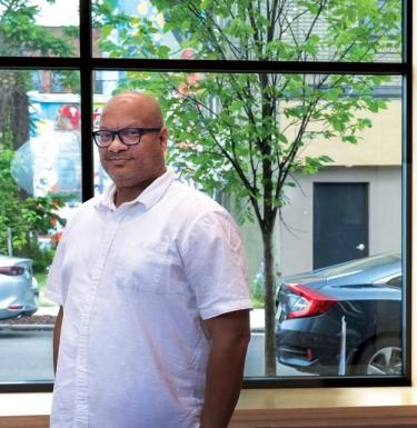 vernard alexander, director of the CEC in homewood, poses for a photo in front of a window at the CEC