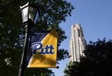 a banner with "pitt" on it and the cathedral in the background