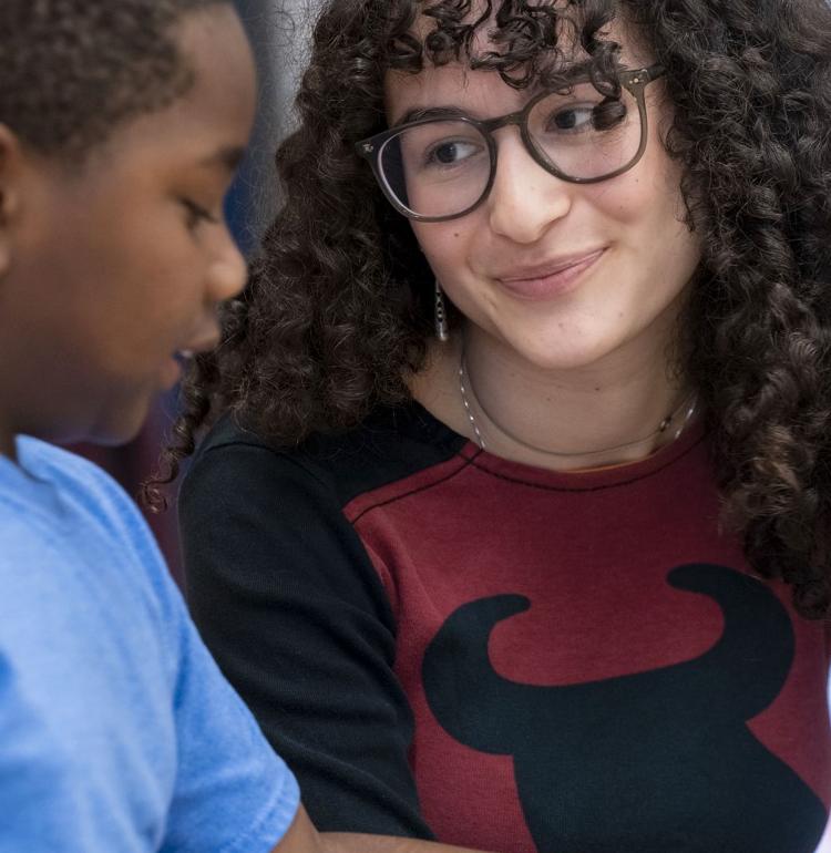 a tutor at pittenrich talks to a student