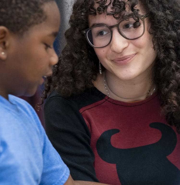 a tutor at pittenrich talks to a student